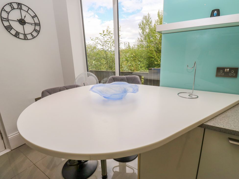 A kitchen with a round table and clock at Nabwood views