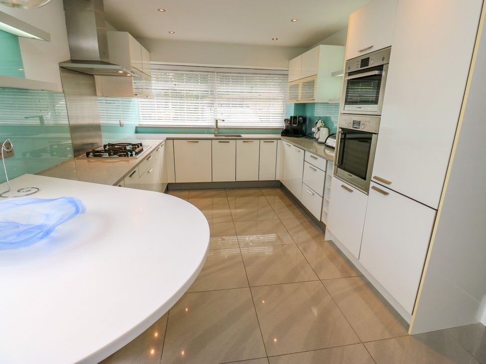 A kitchen with cabinets and appliances at Nabwood views