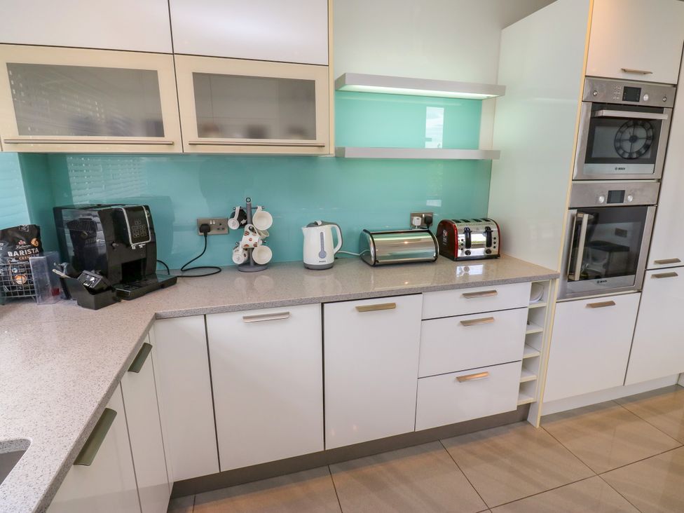 A kitchen with a coffee machine, kettle, and toaster at Nabwood views