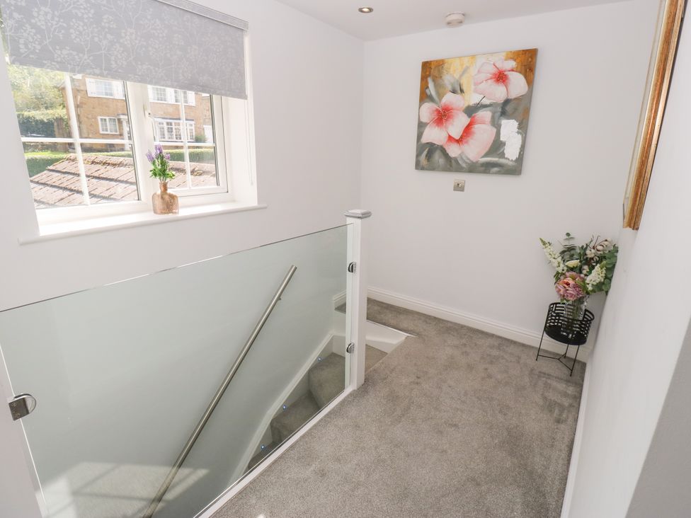 A landing area with a staircase and wall art at Nabwood views
