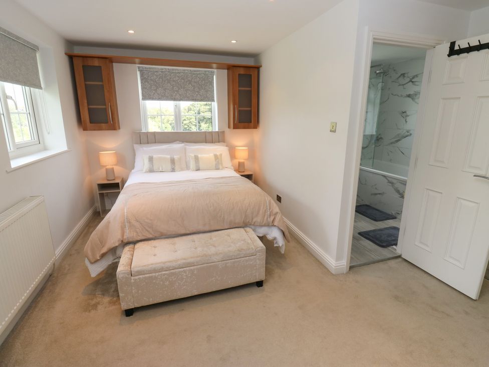 A bedroom with a bed and window at Nabwood views