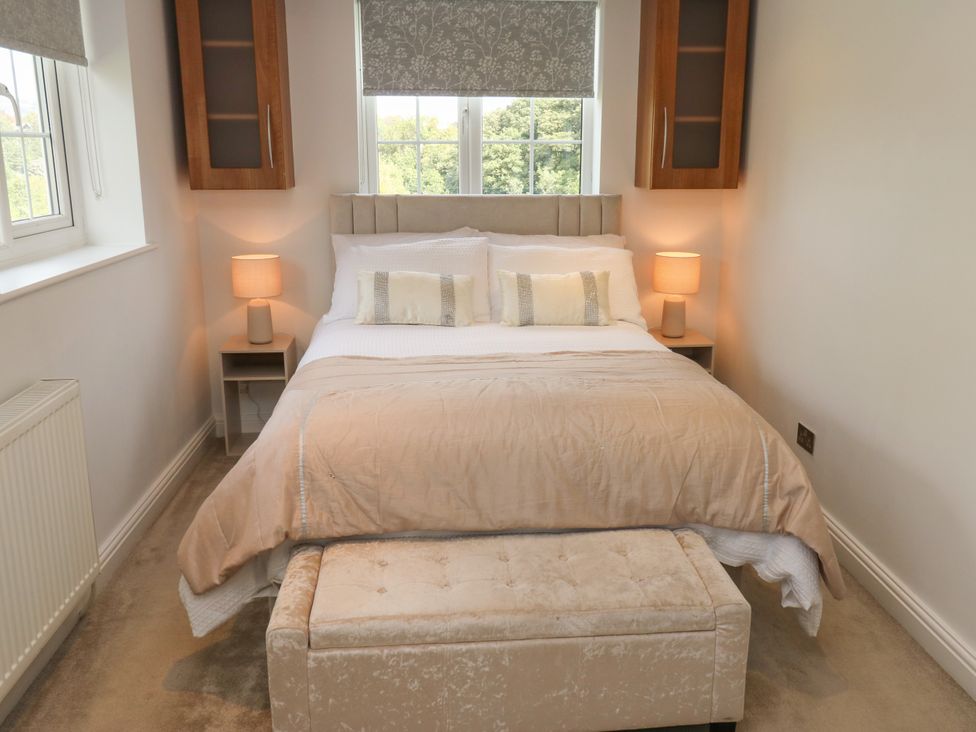 A bedroom with a bed and bedside tables at Nabwood views