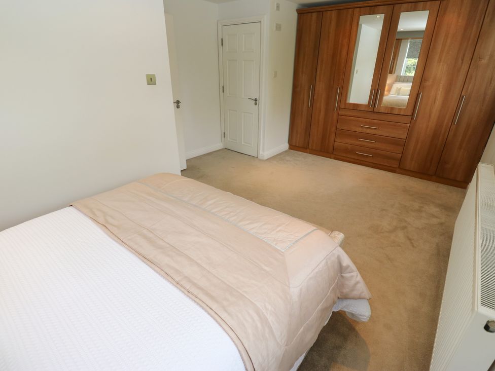 A bedroom with a bed and wardrobe at Nabwood views 