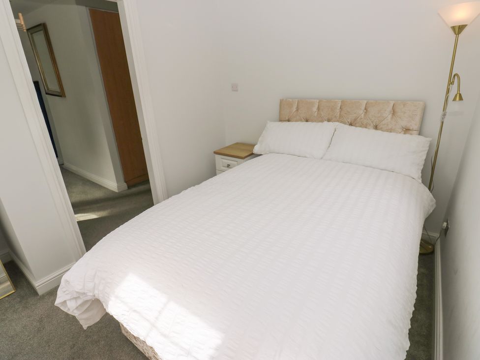 A bedroom with a bed and bedside table at Nabwood views 