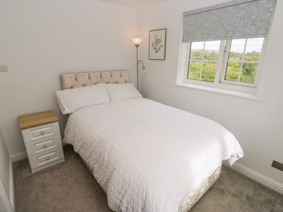 A bedroom with a bed and nightstand at Nabwood views