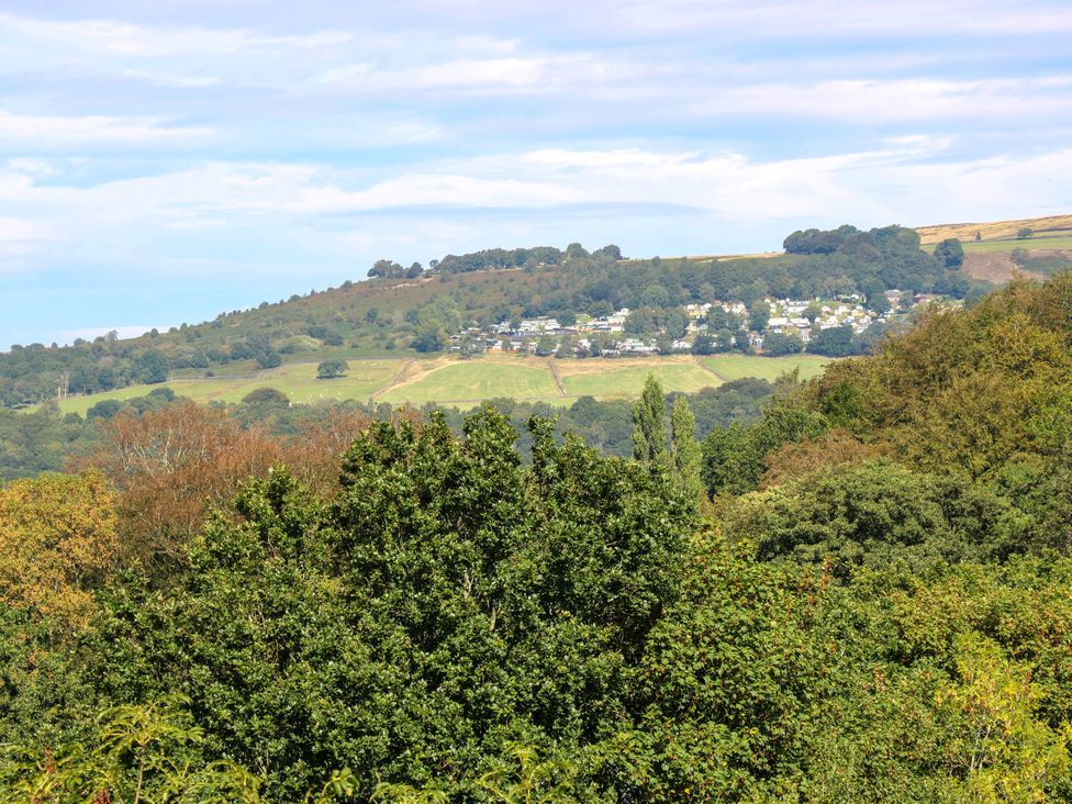A view of hills and cottages surrounded by trees at Nabwood views 