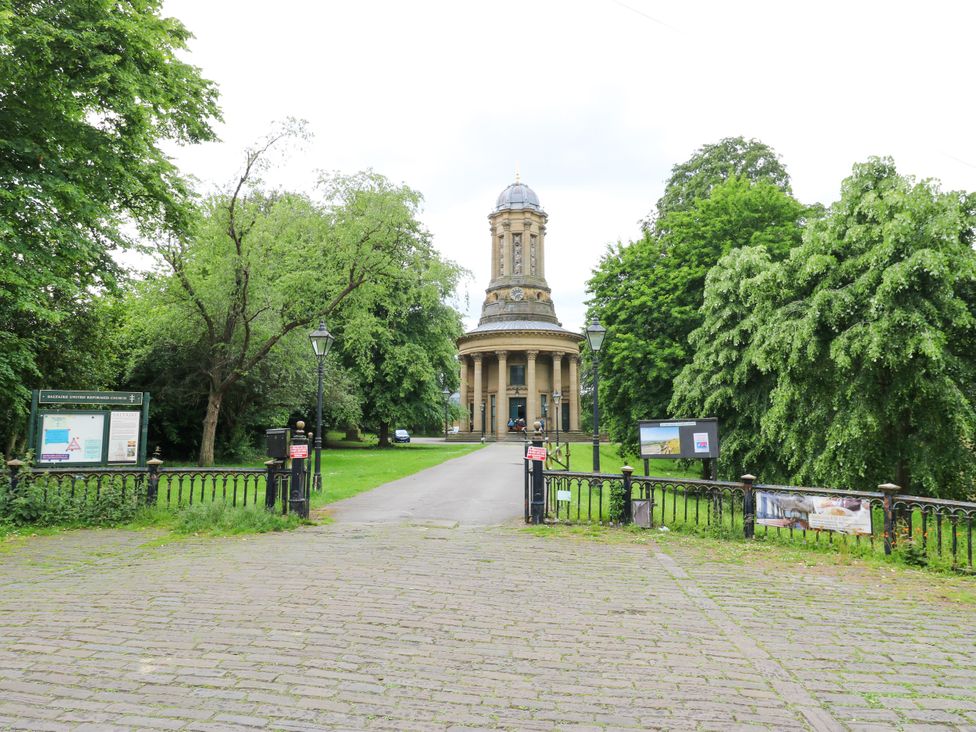 A park scene with a building and trees at Nabwood views