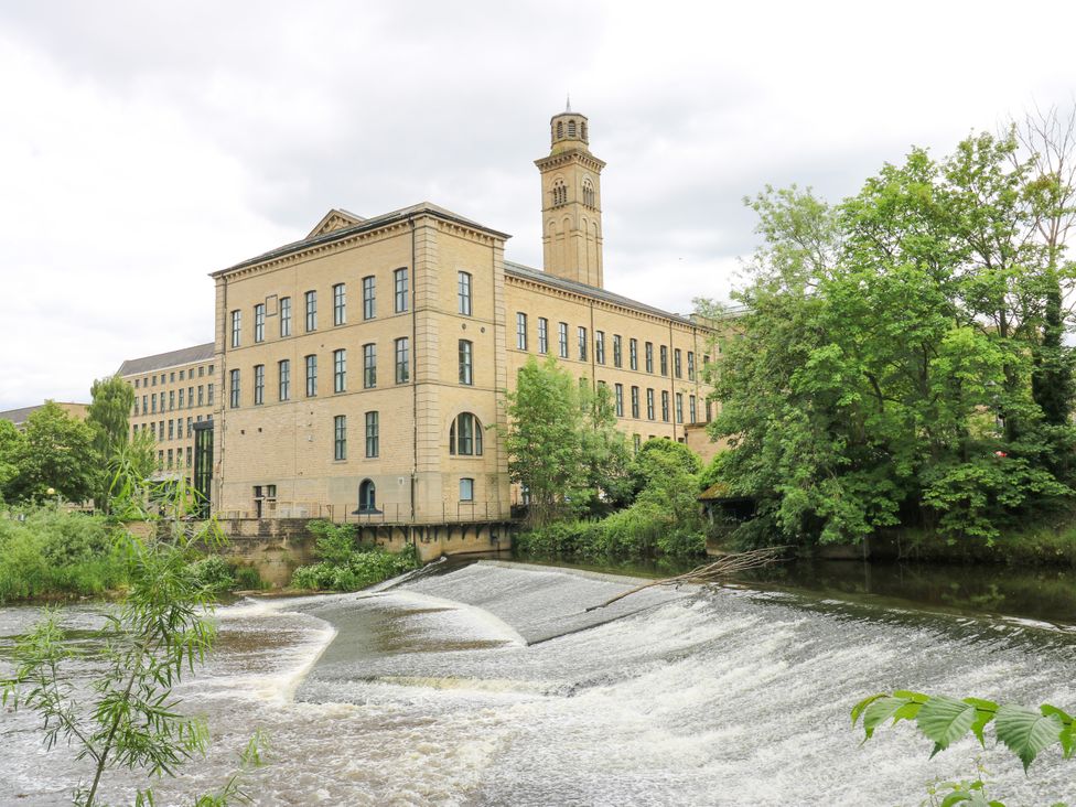 A building beside a river with a waterfall at Nabwood views 