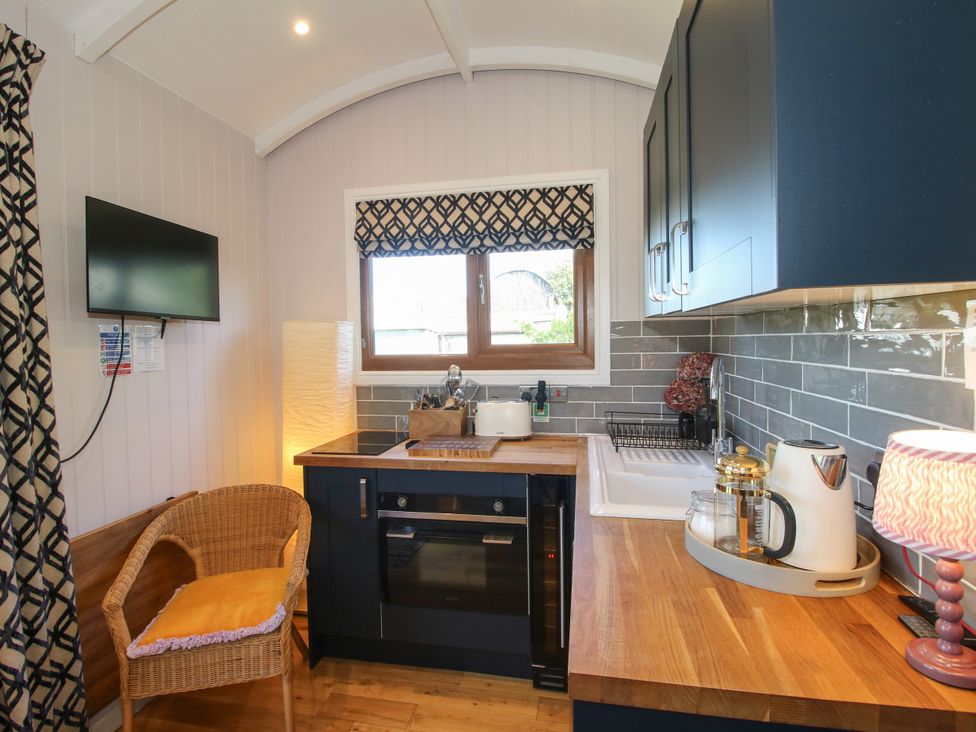A kitchen with a sink and stove at Hideaway Hut at Hopton Court Estate near Cleobury Mortimer