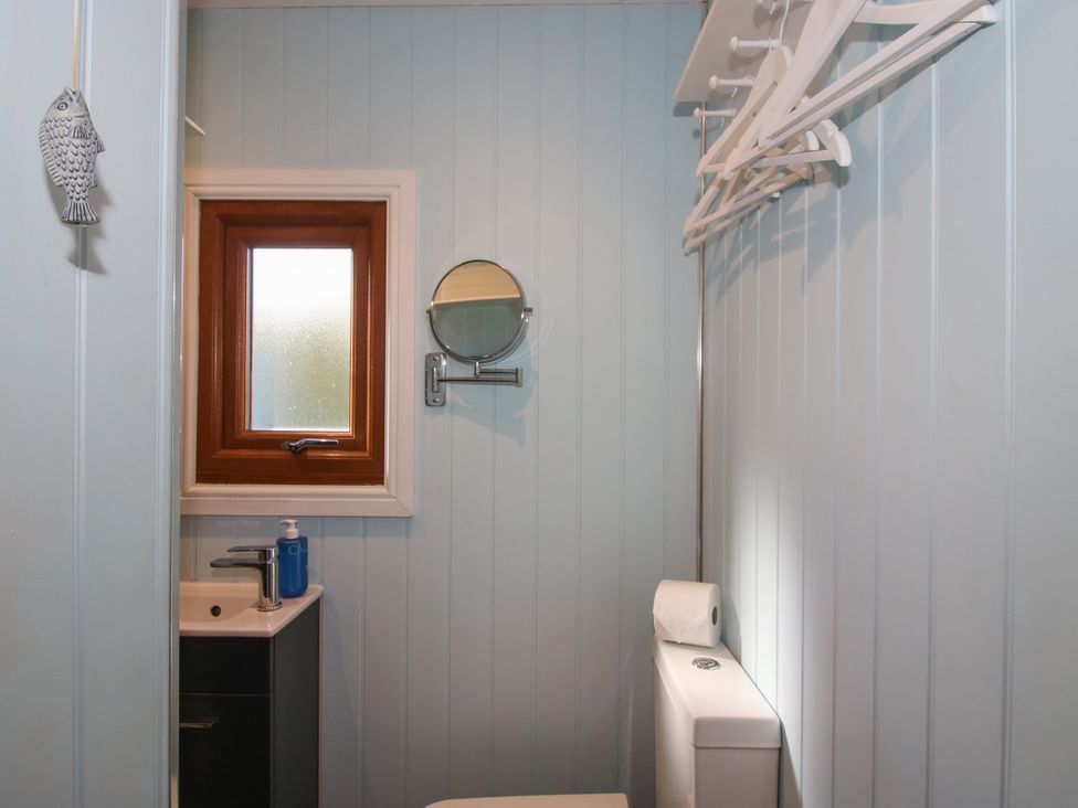 A bathroom with a sink and toilet at Hideaway Hut at Hopton Court Estate Hopton Wafers near Cleobury Mortimer