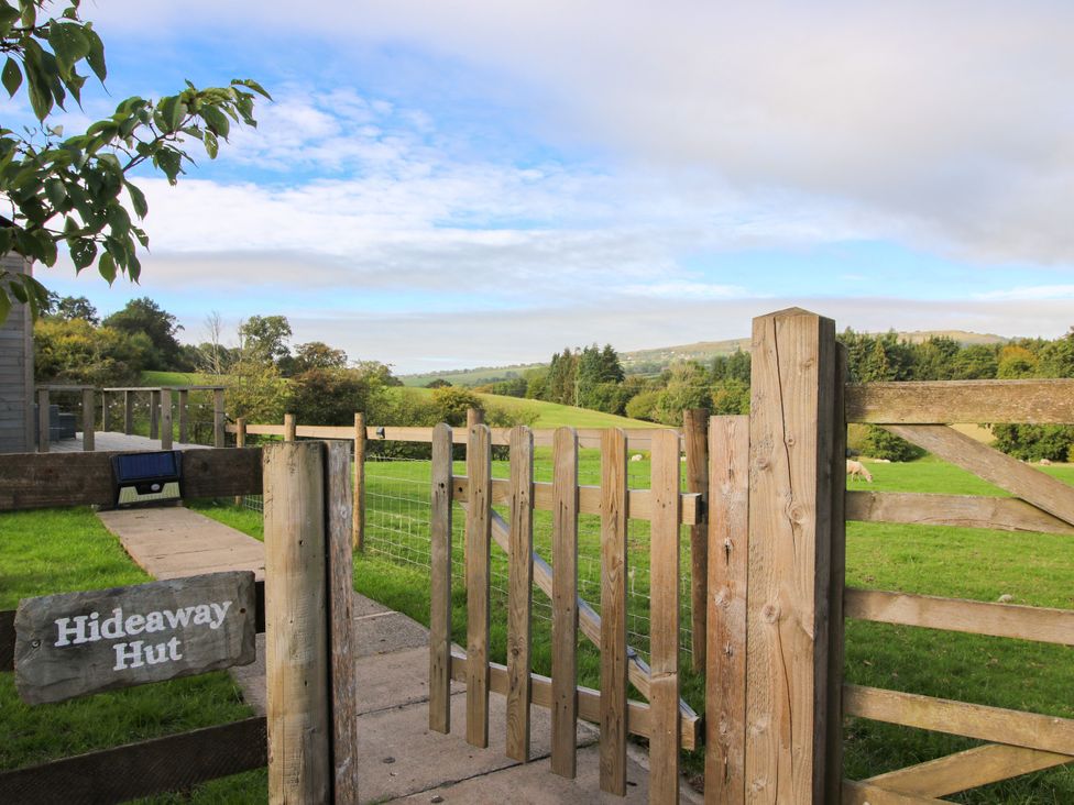 A gate leading to a grassy area at Hideaway Hut at Hopton Court Estate near Cleobury Mortimer