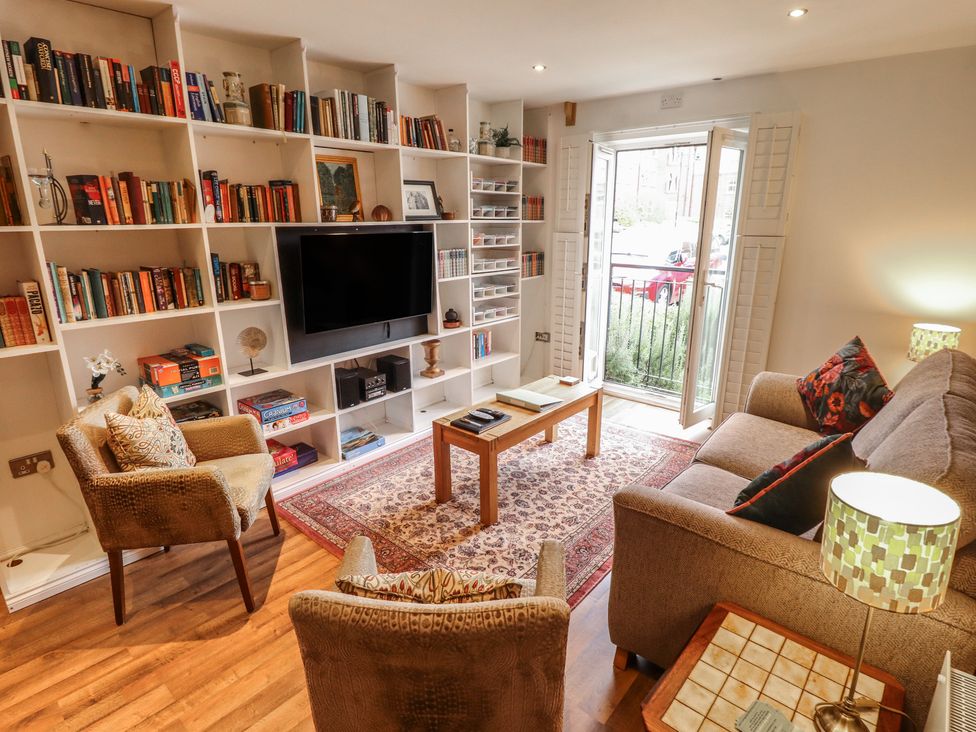 A living room with a television and bookshelf at Apartment 173 in Lincoln