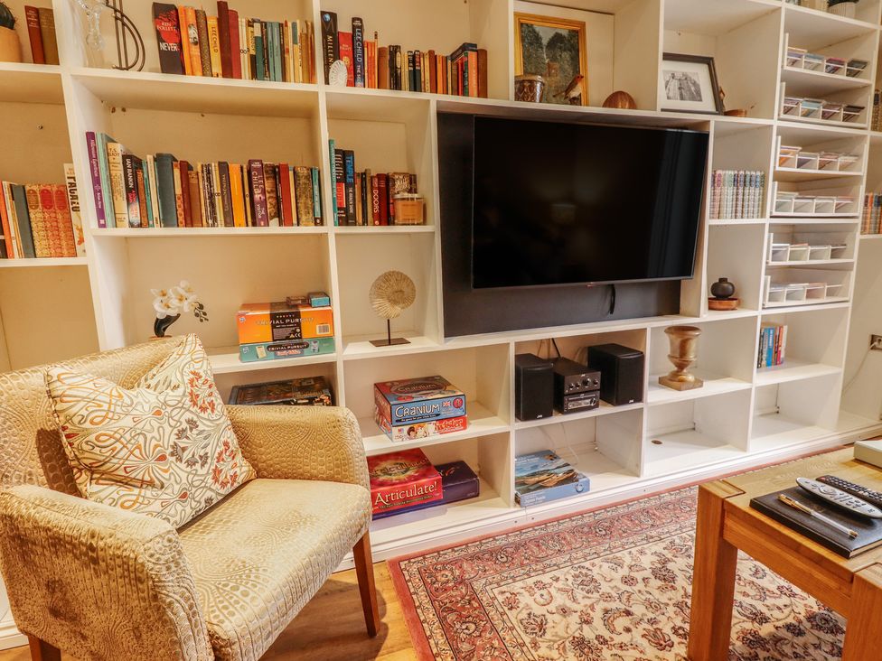 A living room with a television and bookshelves at Apartment 173, Lincoln