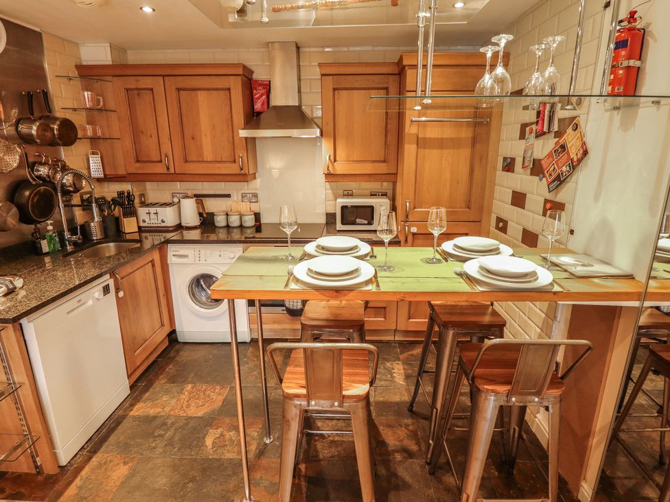 A kitchen with a counter and stools at Apartment 173 in Lincoln