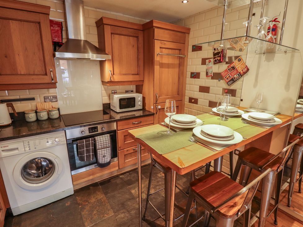 A kitchen with appliances and dining setup at Apartment 173 in Lincoln