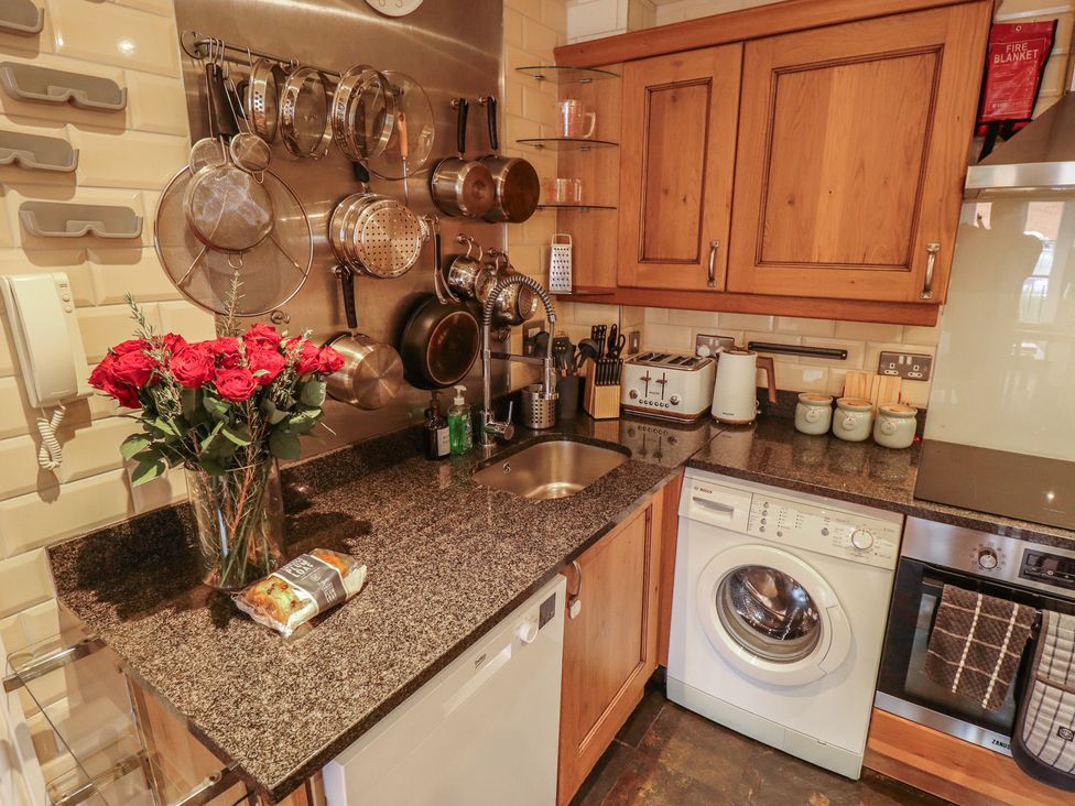 A kitchen with a sink and washing machine at Apartment 173 in Lincoln