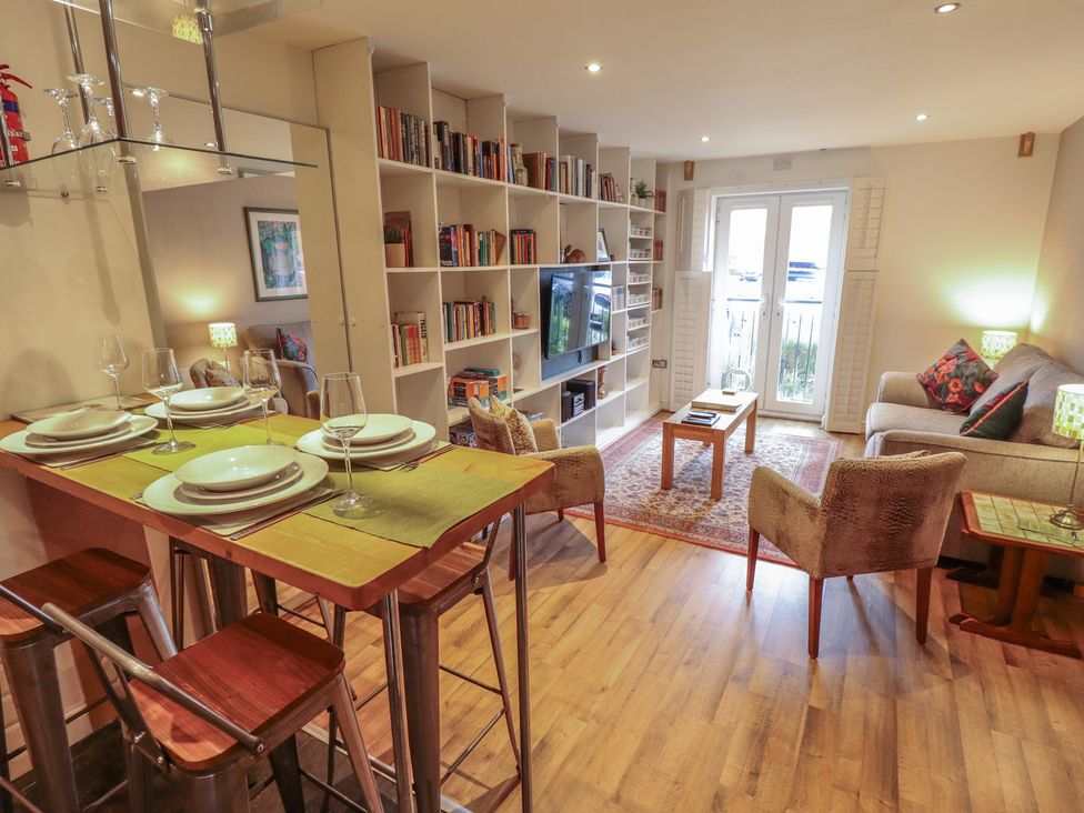 A living room with a dining area and bookshelf at Apartment 173 in Lincoln