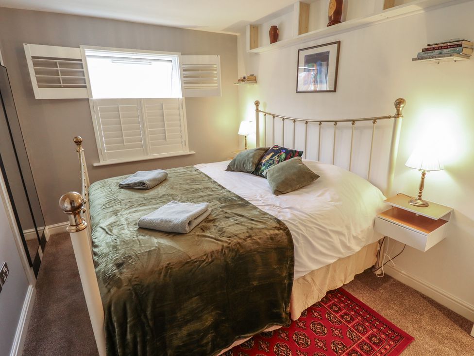 A bedroom with a bed and shelves at Apartment 173 in Lincoln