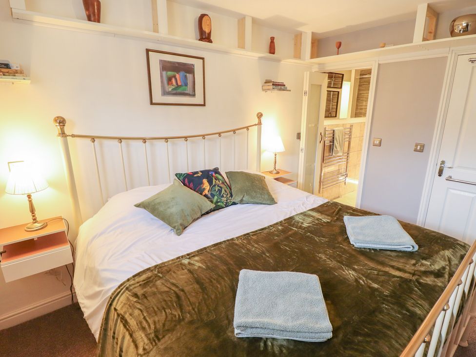 A bedroom with a bed and bedside table at Apartment 173 in Lincoln