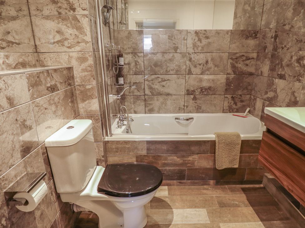 A bathroom with a bathtub sink and toilet at Apartment 173 in Lincoln