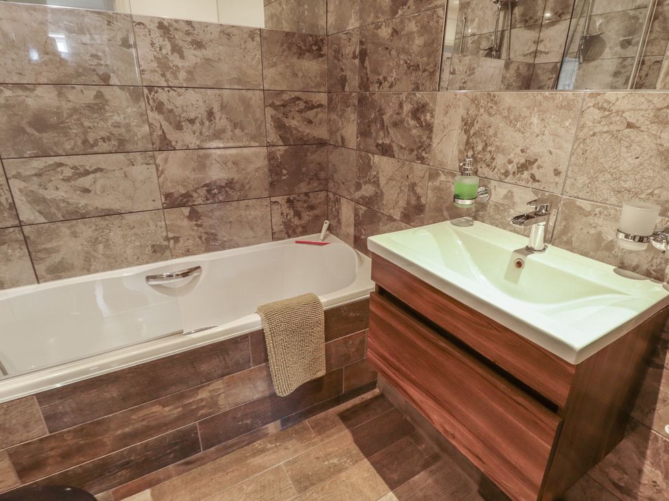 A bathroom with a bath tub and sink at Apartment 173 in Lincoln