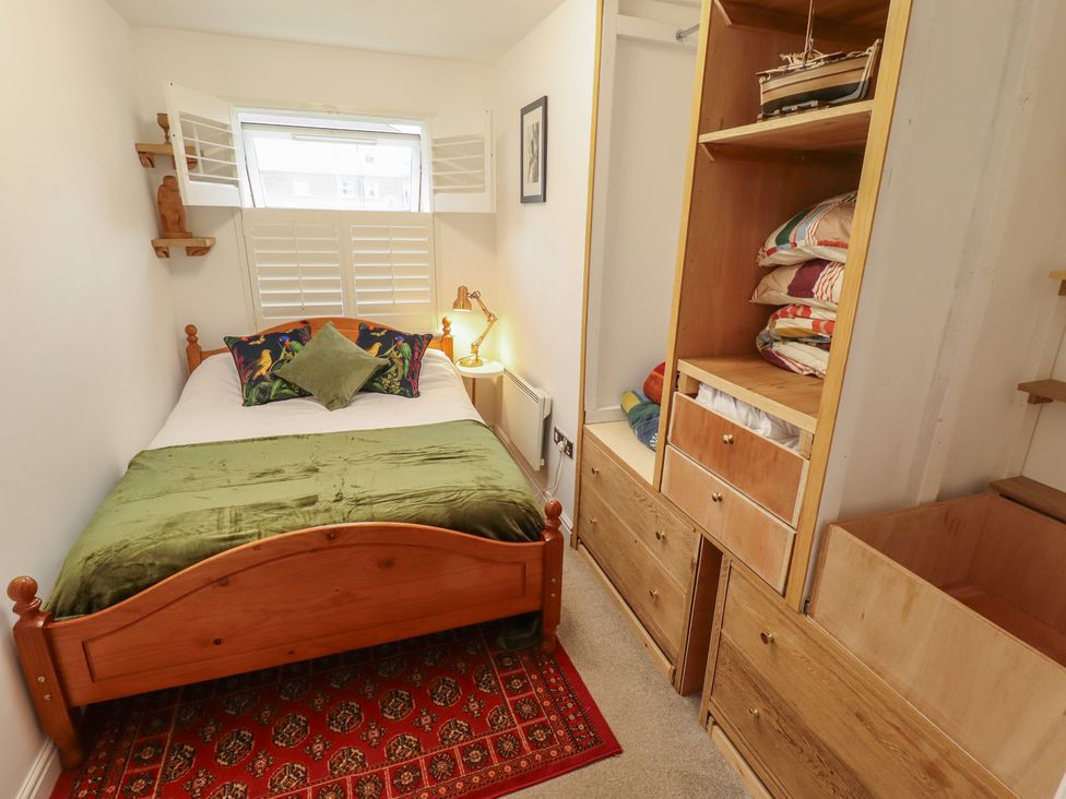 A bedroom with a bed and wooden furniture at Apartment 173 in Lincoln