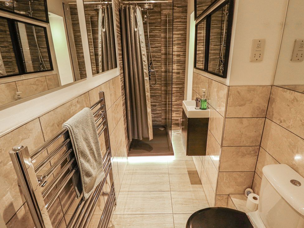 A bathroom with a shower and sink at Apartment 173 in Lincoln
