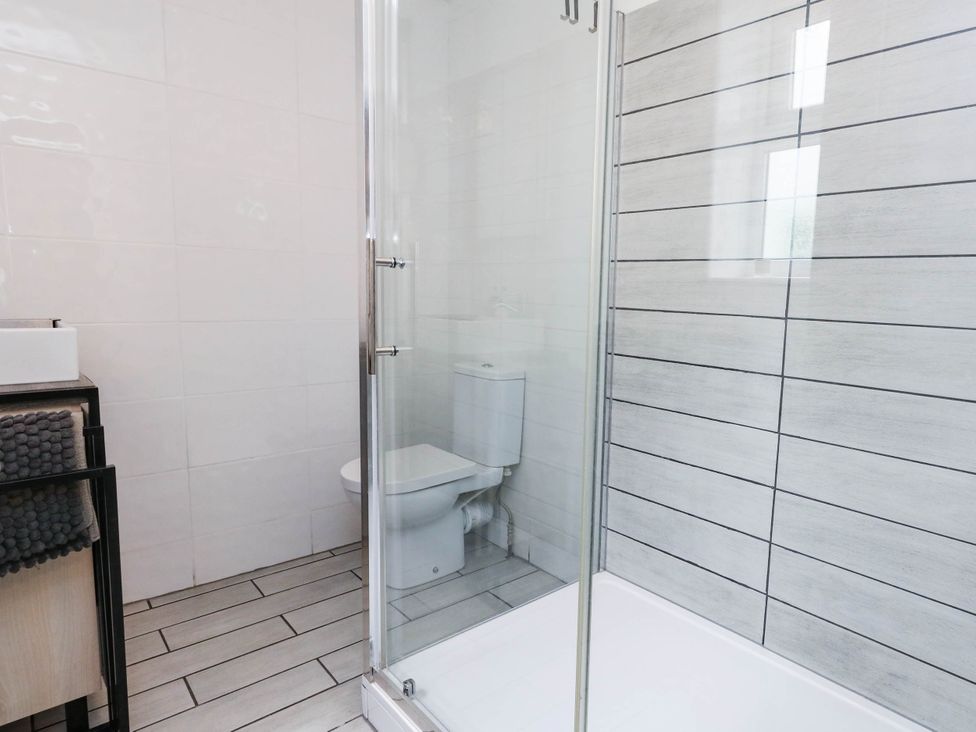 A bathroom with a shower and toilet at Flat 1, 2 Wooperton Street Weymouth