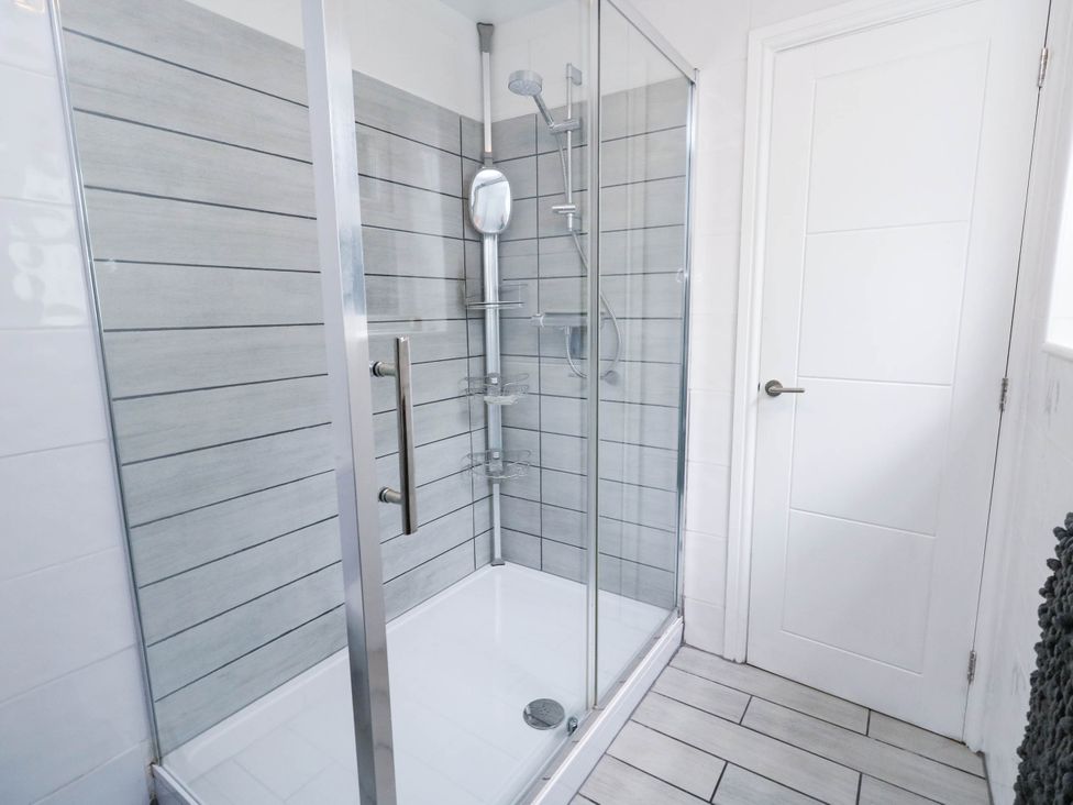 A bathroom with a glass shower enclosure at Flat 1, 2 Wooperton Street Weymouth