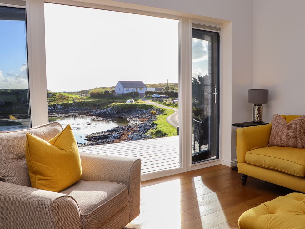 A living room with a view of the landscape at Holm in Strond near Carminish, Isle Of Harris