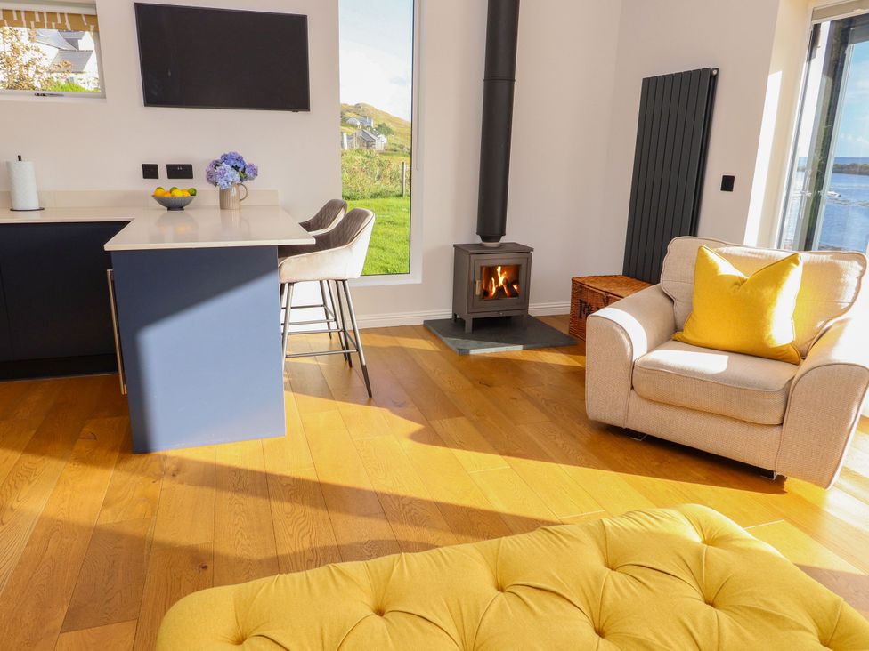 A living room with a sofa and television at Holm in Strond near Carminish, Isle Of Harris
