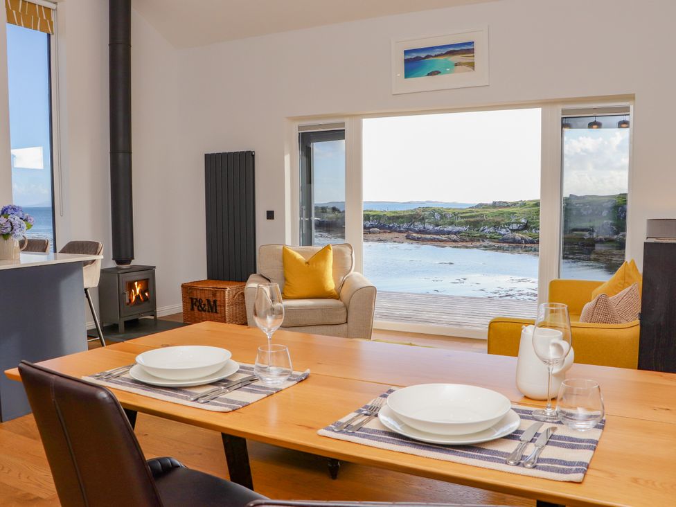 A dining room with a table and chairs at Holm, Strond near Carminish, Isle Of Harris