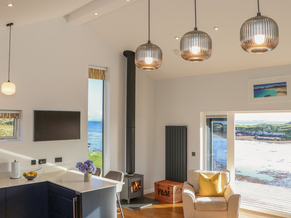 A living room with a sofa and television at Holm, Strond near Carminish, Isle Of Harris