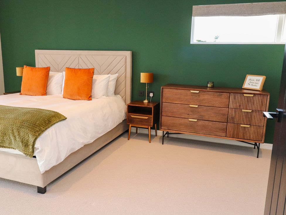 A bedroom with a bed and a dresser at Holm, Strond near Carminish, Isle Of Harris