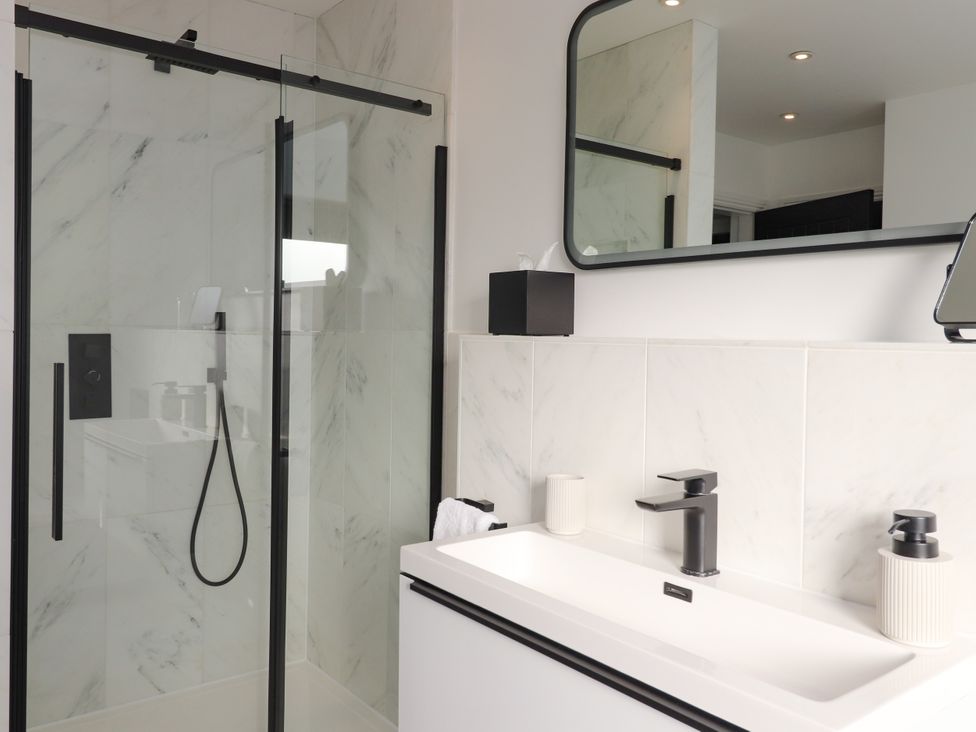 A bathroom with a shower and sink at Holm, Strond near Carminish, Isle Of Harris