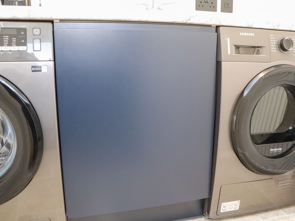 A washing machine and dryer in a laundry room at Holm, Strond near Carminish, Isle Of Harris