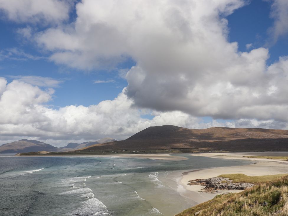 A beach with water and sand at Holm in Leverburgh
