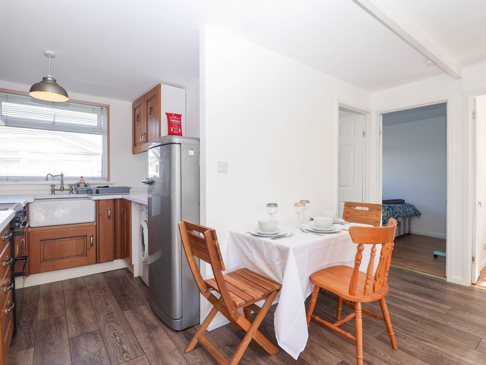 A kitchen with a table and chairs at 122 Norton Park, Dartmouth