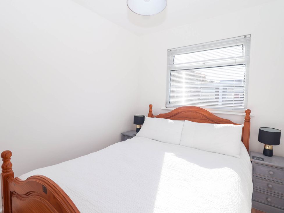 A bedroom with a bed and nightstands at 122 Norton Park Dartmouth