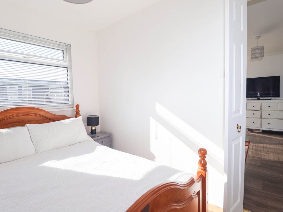 A bedroom with a bed and a nightstand at 122 Norton Park in Dartmouth