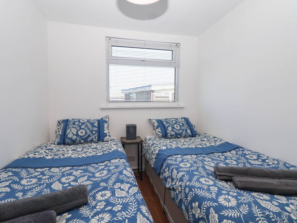 A bedroom with two beds and a window at 122 Norton Park, Dartmouth