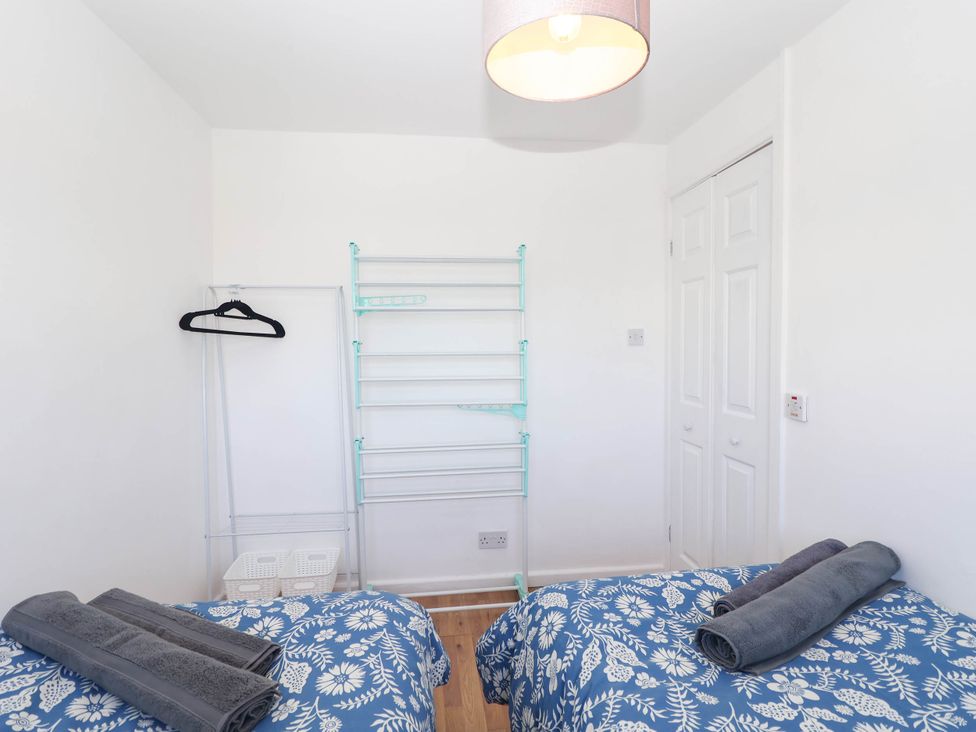 A bedroom with two beds and towels at 122 Norton Park in Dartmouth