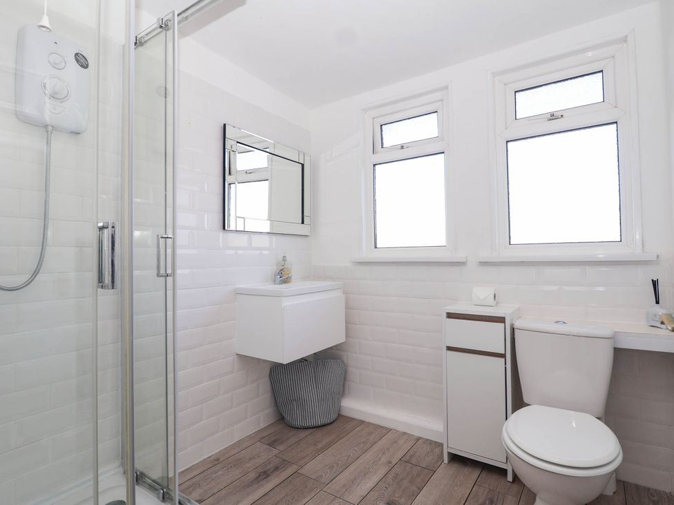 A bathroom with a shower, sink, and toilet at 122 Norton Park in Dartmouth