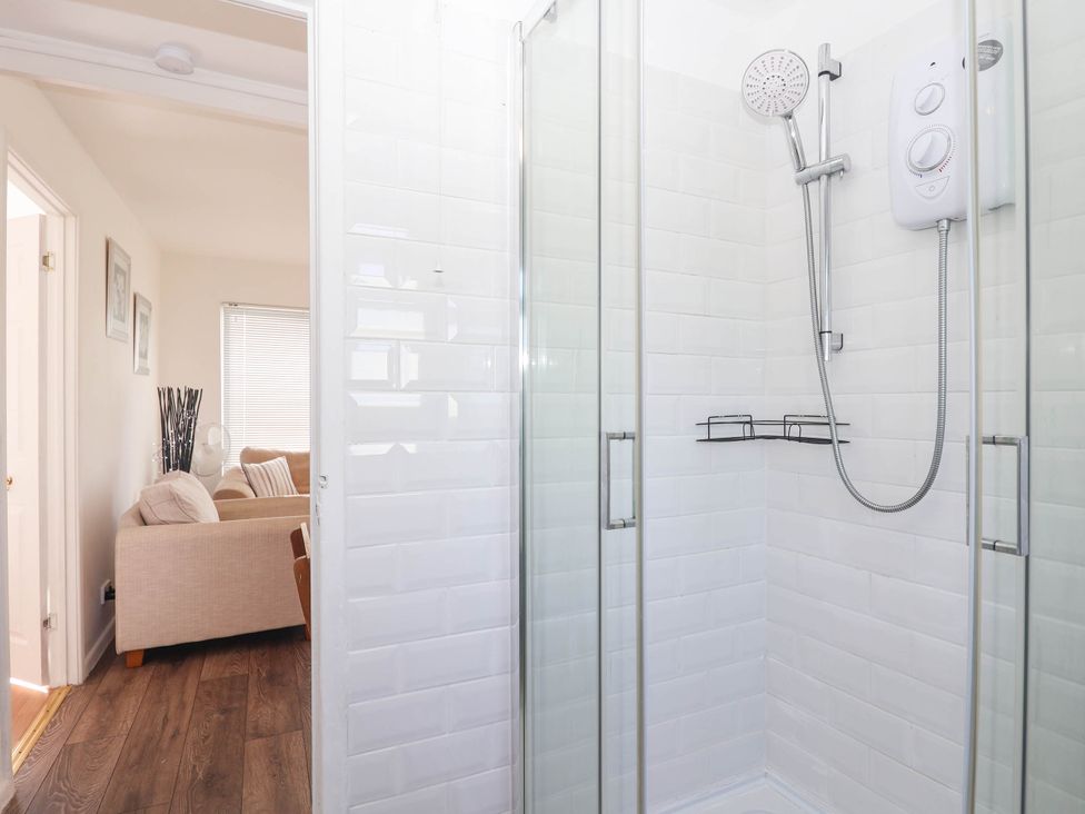 A shower enclosure with a showerhead and shelf at 122 Norton Park Dartmouth