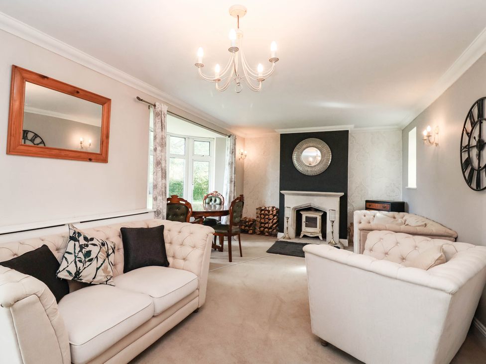 A living room with a sofa and table at Herriotts Bridge Cottage in Bristol