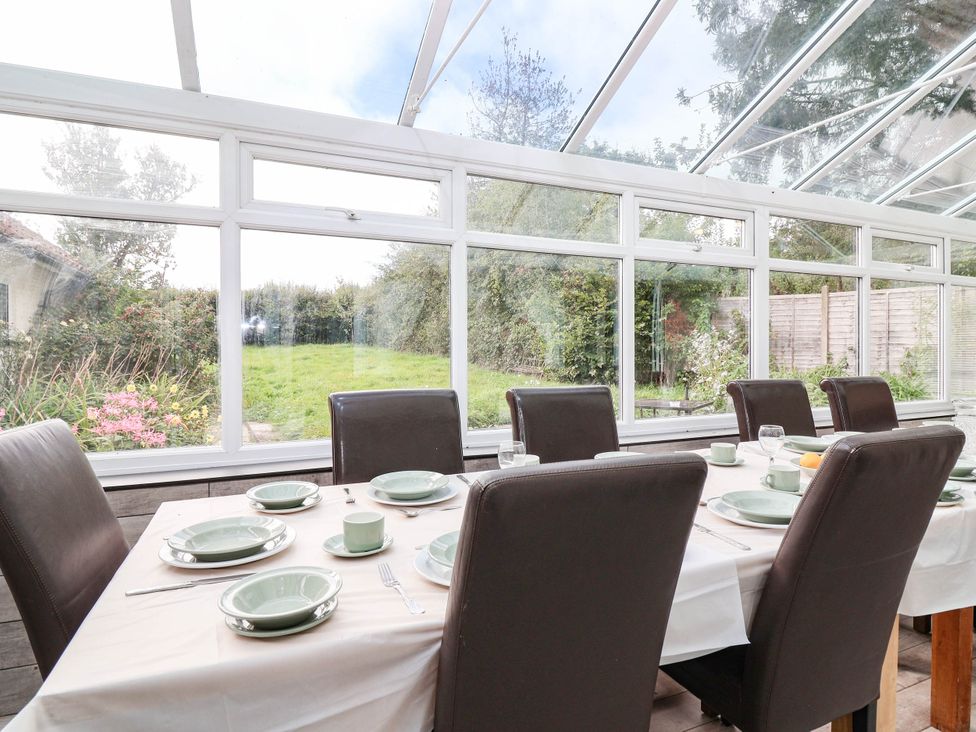 A dining table set with plates and cups at Herriotts Bridge Cottage in Bristol