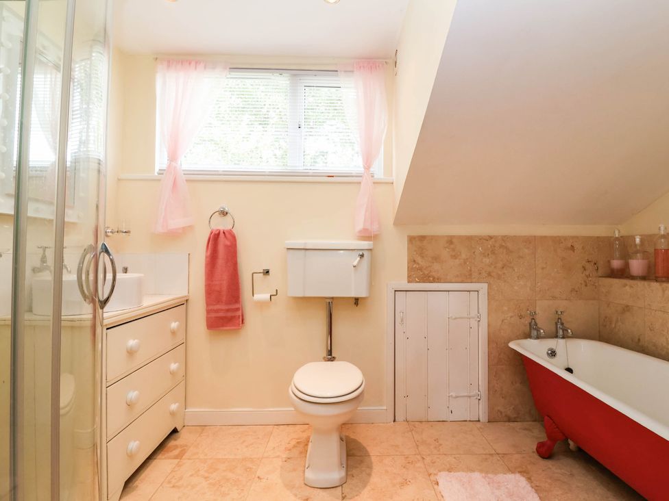 A bathroom with a shower, sink, toilet, and bathtub at Herriotts Bridge Cottage in Bristol