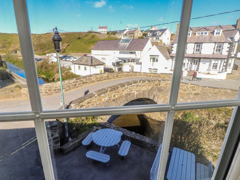 A view from a window showing a bridge and buildings at Hen Blas Pwllheli