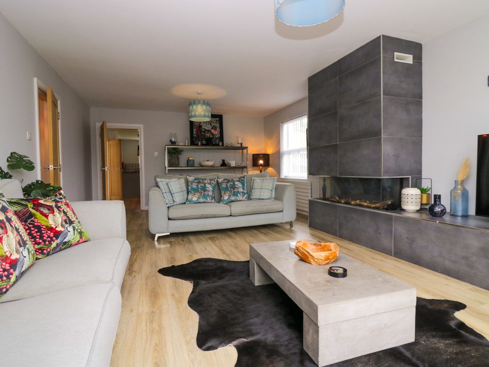 A living room with a sofa and coffee table at 10 Rayrigg Rise Bowness-On-Windermere