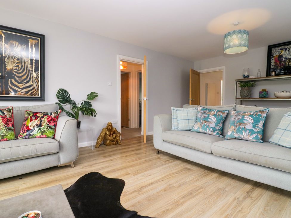 A living room with a sofa and artwork at 10 Rayrigg Rise Bowness-On-Windermere